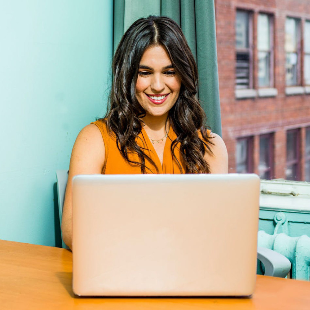 Smiling professional woman at laptop
